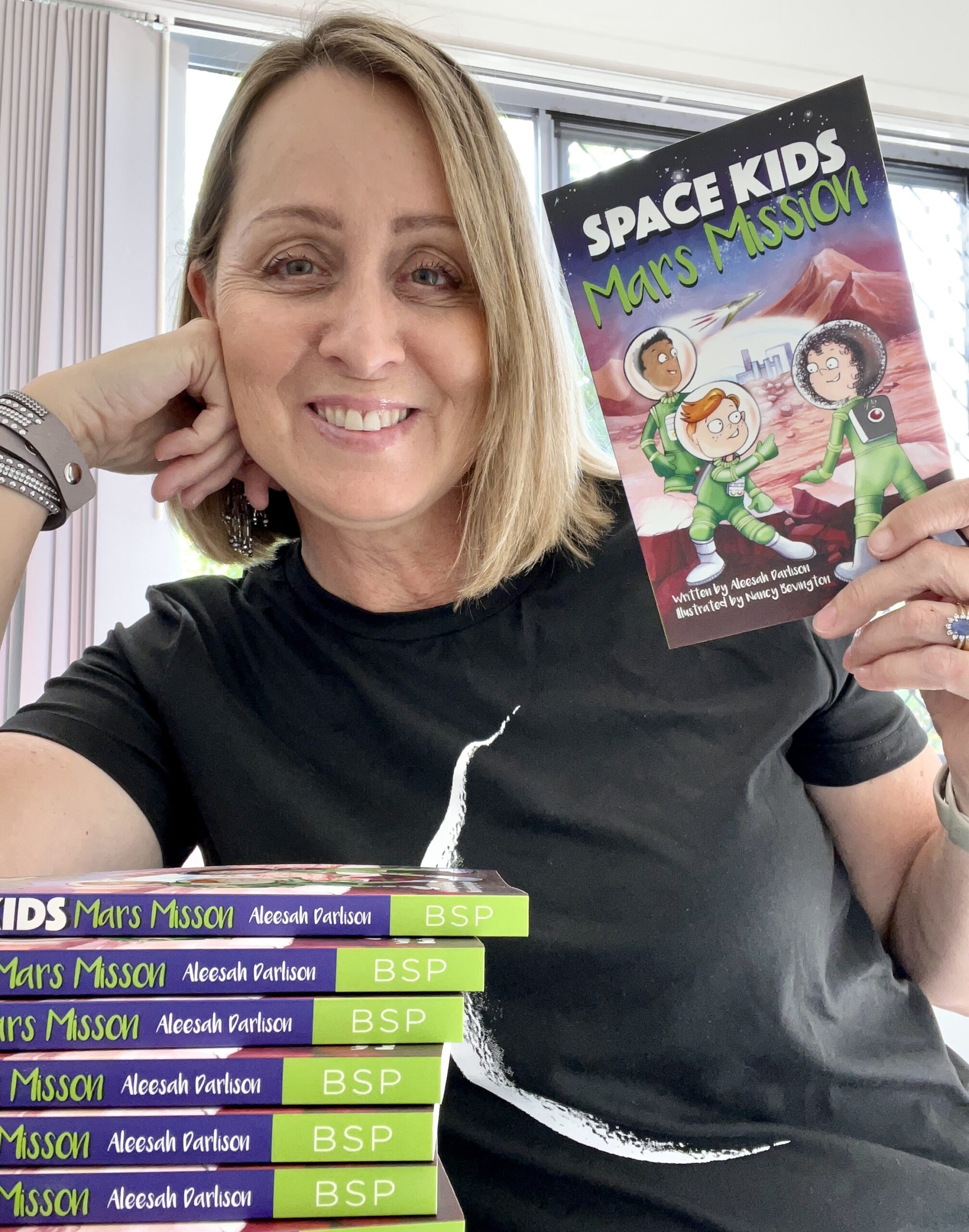 Aleesah Darlison pictured smiling with new book Mars Mission