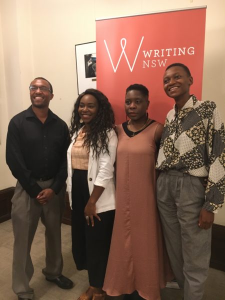 panelists Tyree, Kaiya, Eugen and Moreblessing standing in front of the Writing NSW banner