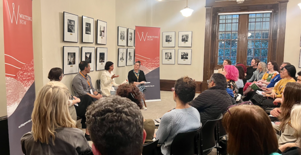 A wide shot of a crowd of people facing authors Hayley Scrivenor, Nick Bhasin and Zaheda Ghani speaking to Rowena Tuziak, at a room at Writing NSW, Garry Owen House.